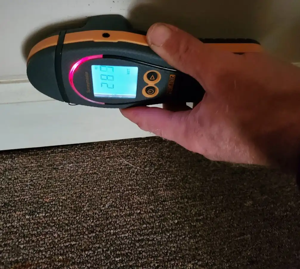 Moisture detection at baseboard during Storm Damage Restoration in Keyes
